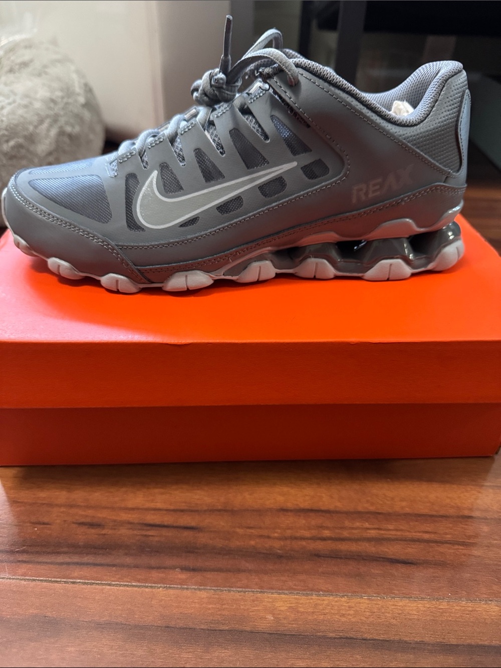 Nike Gray and White Running Shoe with Visible Swoosh